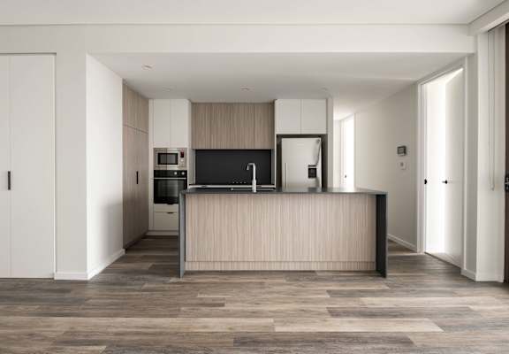 a kitchen with white cabinets and a wooden counter top