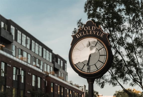 a clock on a pole in front of a building