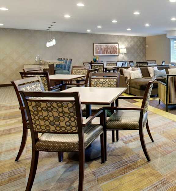 A dining room with a table surrounded by chairs. at The Preserve at Commerce, Rogers, 55374