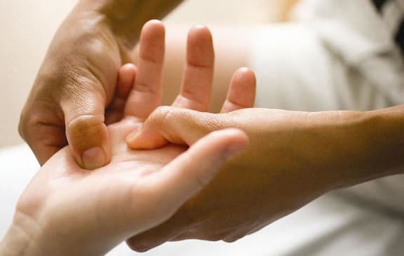 a person holding their fingers in their hands