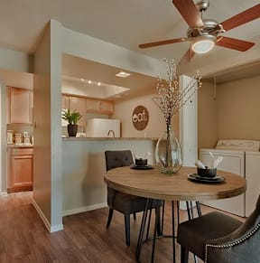 A dining room with a round table and chairs. at Sycamore Square  Apartments, Arizona, 85202