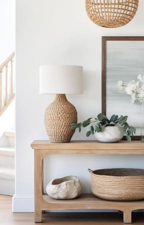 a living room table with a lamp near a staircase  at Pinewood Townhomes in Tucker, Georgia 30084