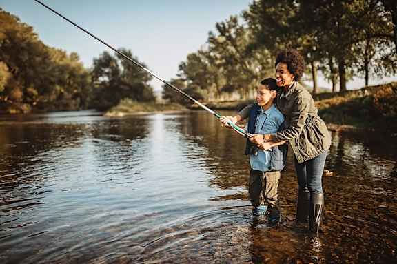 Two people are fishing in a river at Casa Estilo Apartments, Chula Vista, CA