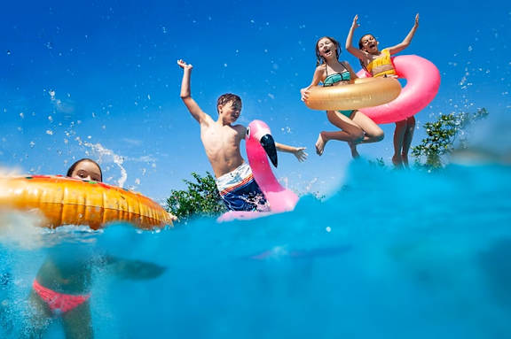 A group of people are enjoying in the water at Casa Estilo Apartments, California