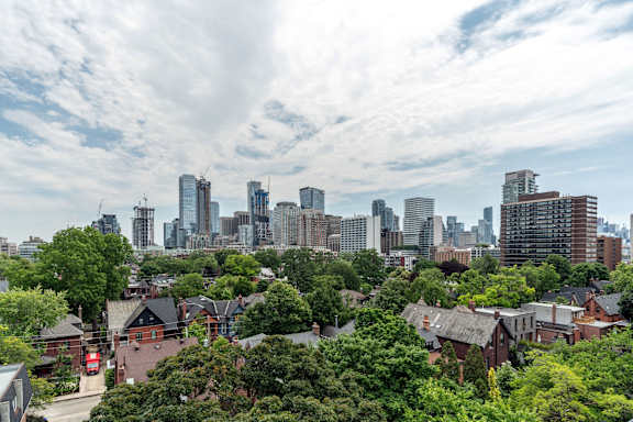 A cityscape with a mix of residential and commercial buildings. at 177 Saint George in Toronto, CA