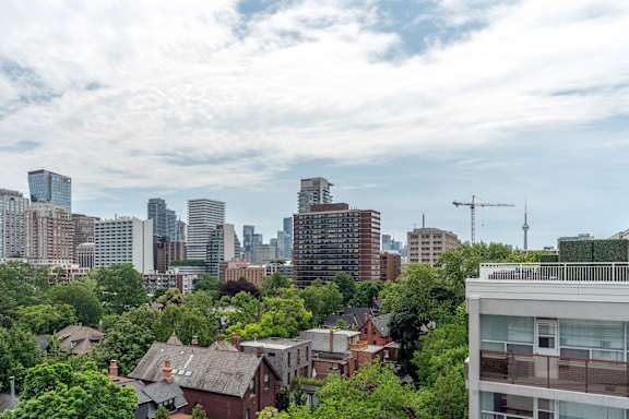 A cityscape with a mix of residential and commercial buildings. at 177 Saint George in Toronto, CA