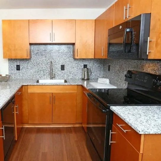 a kitchen with wooden cabinets and granite counter tops