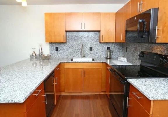 a kitchen with wooden cabinets and granite counter tops