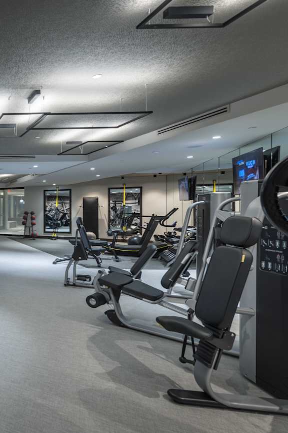 A gym with treadmills, exercise bikes, and other equipment.