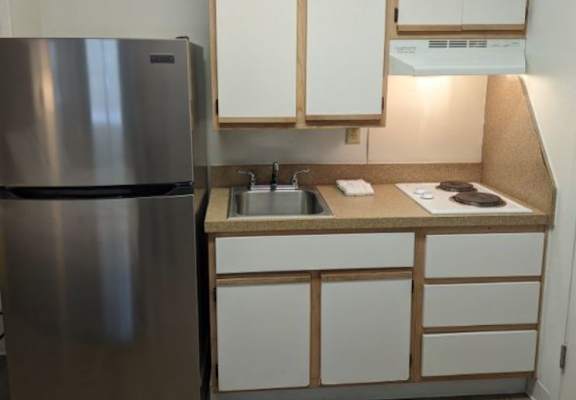 a kitchen with a sink and a refrigerator  at Waterford Studios, Texas, 78758