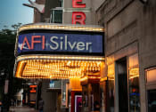 Thumbnail 2 of 9 - the neon sign for the afl silver theatre at dusk