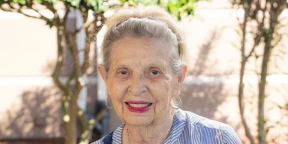 an older woman with a smile on her face