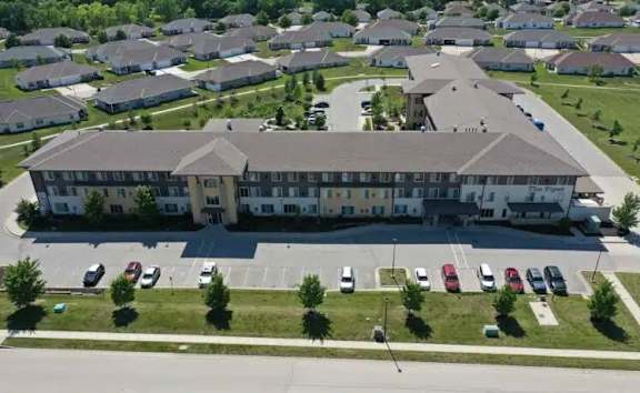 A large building with a parking lot in front of it.