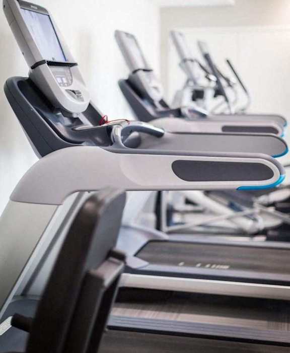 A row of treadmills in a gym.