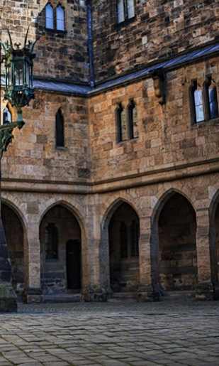 A large stone building with a doorway and arches.