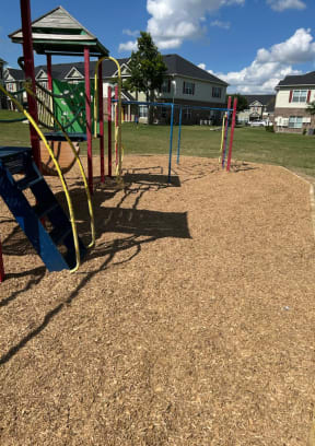 a playground with a swing set in a park