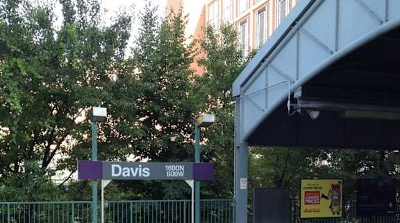 A train is on a bridge over a street.