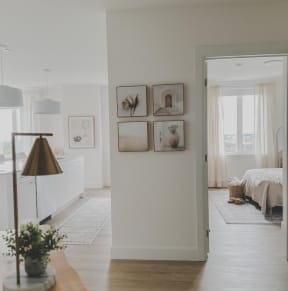 a white living room with pictures on the wall