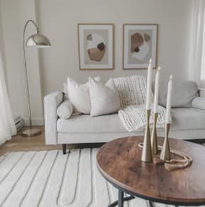 a living room and dining room with a wooden table and chairs