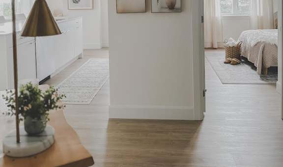 a white living room with pictures on the wall