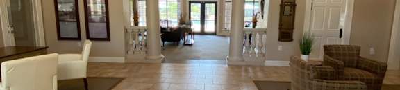 a large hallway with chairs and tables and a couch
