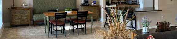 a living room and dining room with a table and chairs