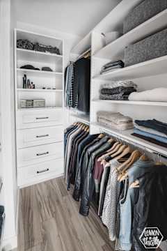 A well-organized closet with clothes and shelves.