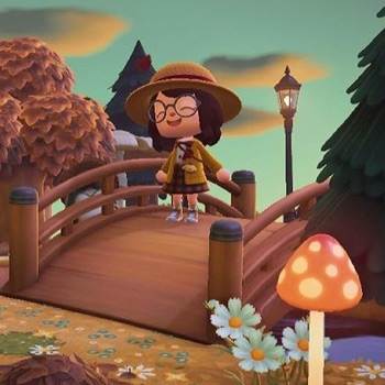 A character in a yellow outfit stands on a bridge in a colorful, animated landscape.