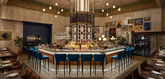 a rendering of a restaurant with a large bar and blue chairs