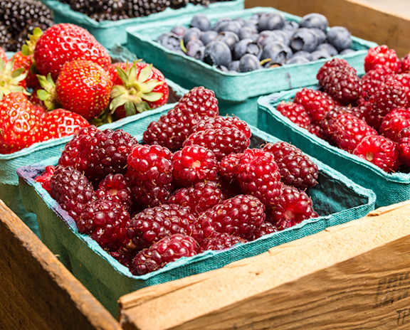 a display of berries at a farmers market