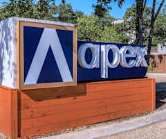 A wooden sign with the word "apex" on it.
