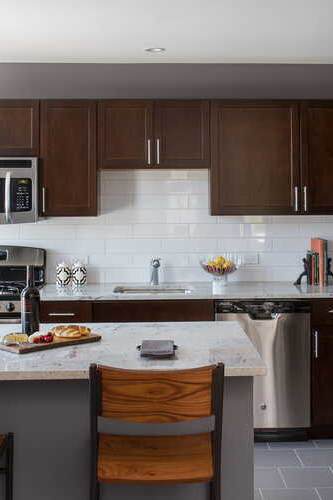 A kitchen with brown cabinets and a white refrigerator.