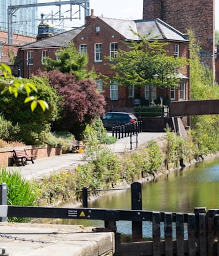 a view of the outside of the building of the tube station at The Trilogy Apartments, Manchester, M15 4RU