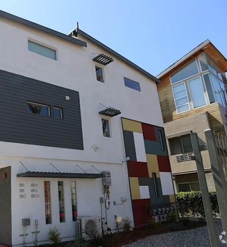 A white building with a red trim and a black door.
