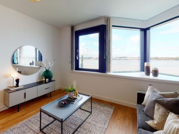 a restaurant with blue doors and white tables and chairs at The Keel Apartments, Liverpool, L3 4GE
