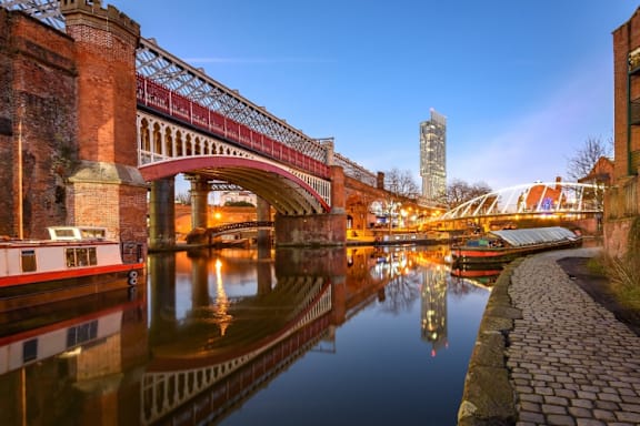 a view of a bridge over a river in a city at The Trilogy Apartments, Manchester, M15 4RU