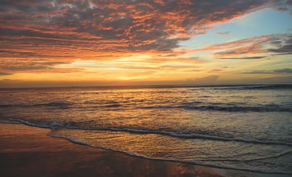 A beautiful beach scene with waves gently rolling in.