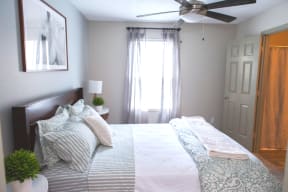 The Southern Apartments Sun-Filled Bedroom with Large Window and Ceiling Fan