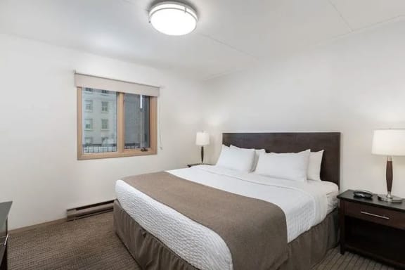 a bedroom with a large bed and a window