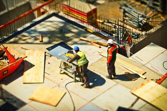 two construction workers working on a building