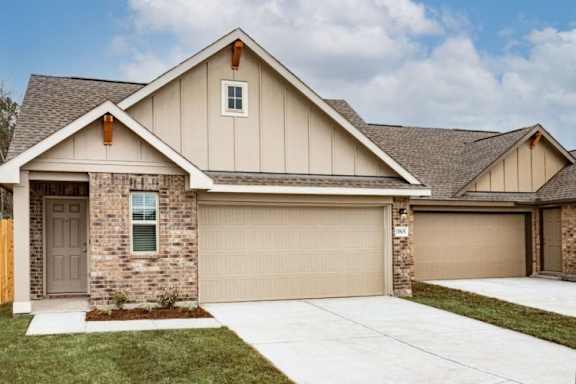 A house with a brown garage door and a grey door.