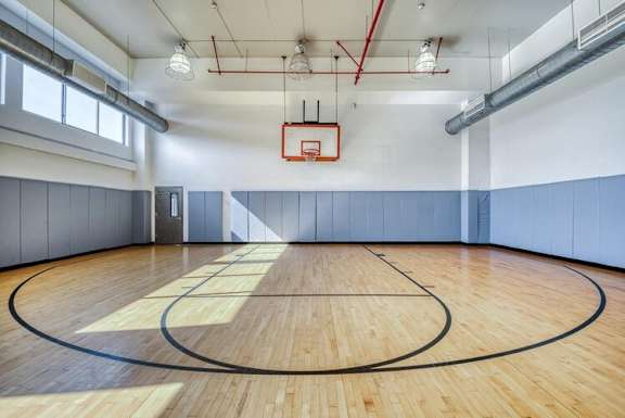 A basketball court with a wooden floor and a basketball hoop.at 66 Main, New York, 10701