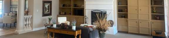 a living room with a fireplace and a table