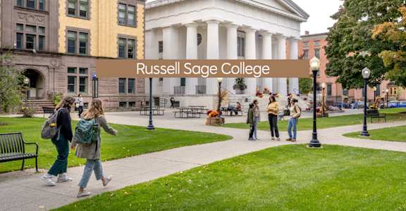 A group of people are walking in front of a building with a sign that says Russell Sage College.