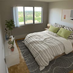a bedroom with a bed with a striped comforter and green pillows