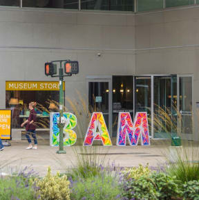 a sign with the word bam in front of a museum