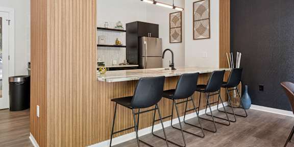 a rendering of the anchorage on heath reception area with a round table and green chairs at The Anchorage on Kelly, Pennsylvania