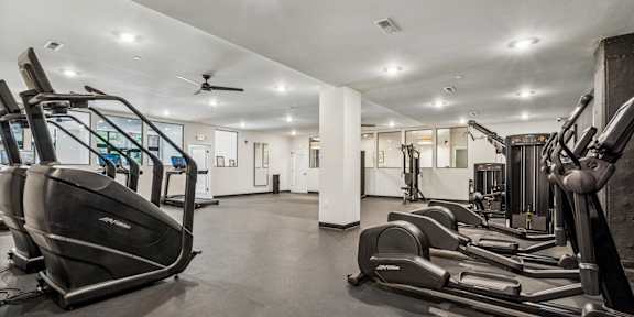 a room filled with lots of different types of exercise equipment at The Anchorage on Kelly, Pennsylvania