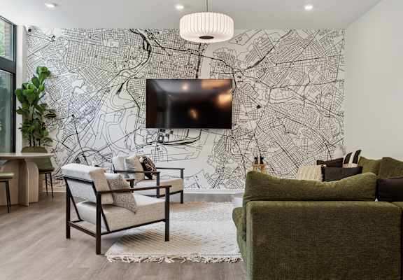 A living room with a large map on the wall and a flat screen TV mounted above it.