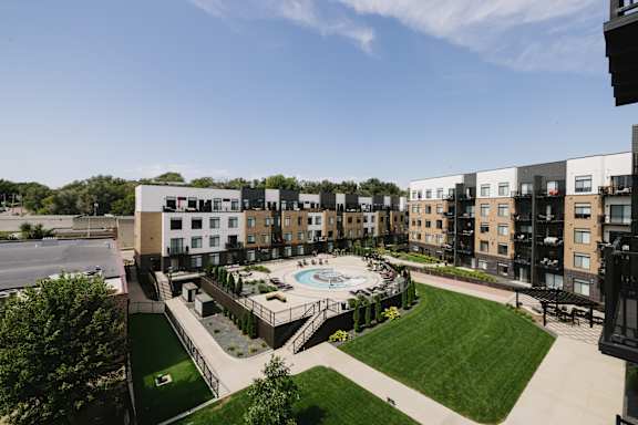 A view of a courtyard with a pool and apartment buildings.
